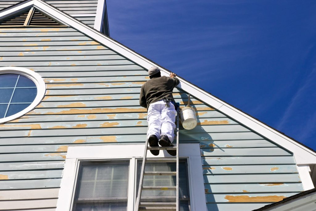 Man painting the house exterior